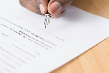 person writing on white paper